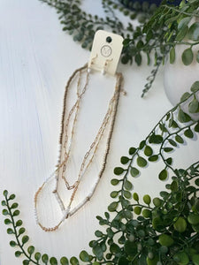 gold chain and white bead necklace pair